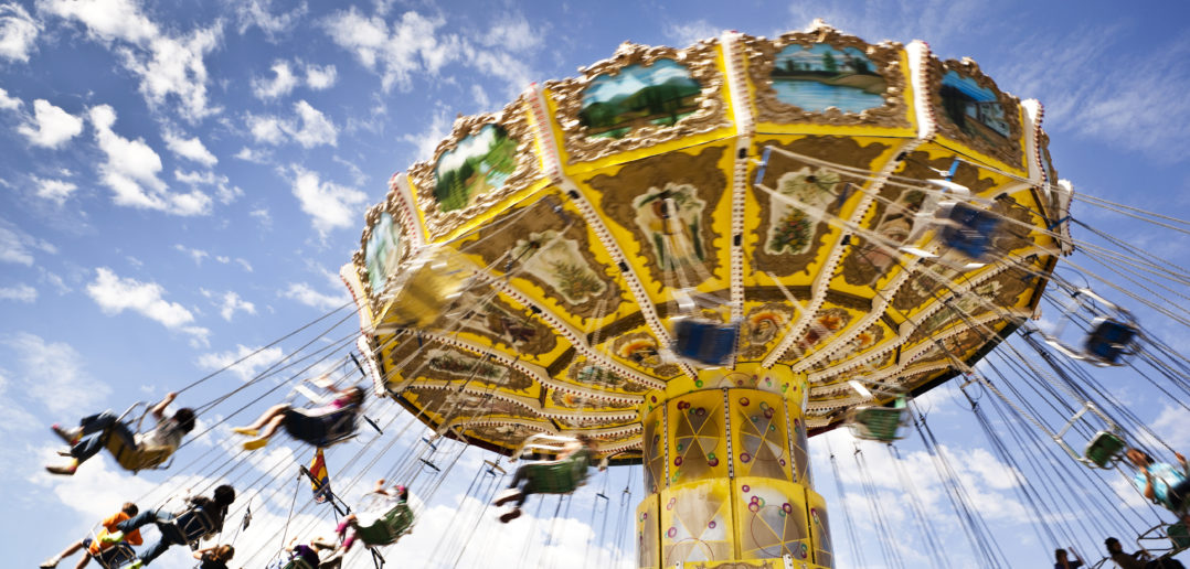 A carnival ride with swings in motion on a cloudy day leisure