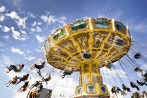 A carnival ride with swings in motion on a cloudy day leisure