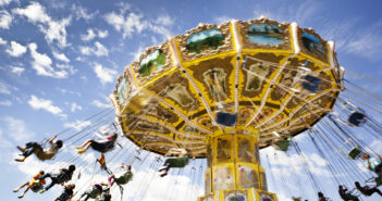 A carnival ride with swings in motion on a cloudy day leisure