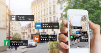 Augmented Reality (AR) information technology about nearby businesses and services on smartphone screen guide customer or tourist in the city, close-up of hand holding mobile phone, blurred street